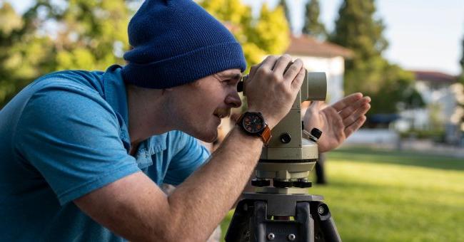 A student looking through a telescope